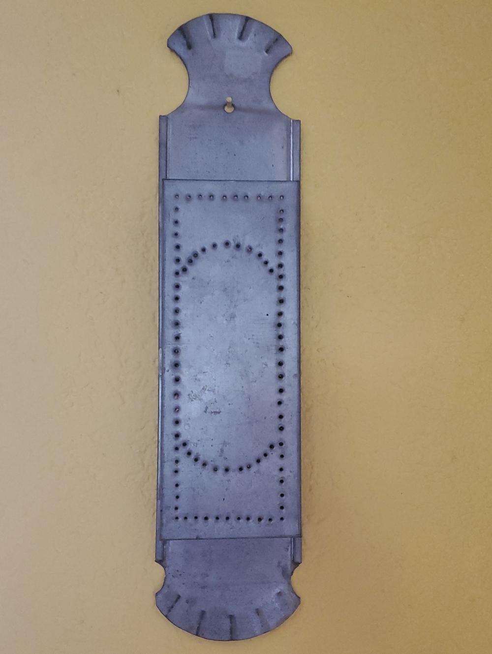 Vintage punched tin wall-mounted match safe/ holder.